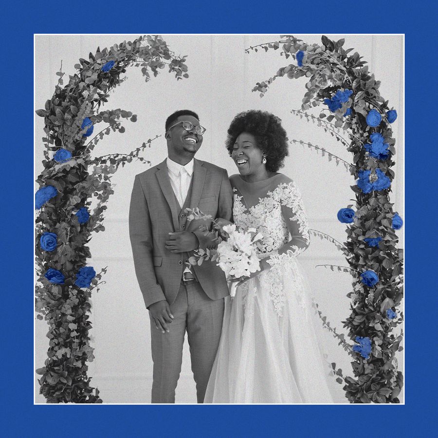 bride and groom under floral arch with marseille bleu flowers