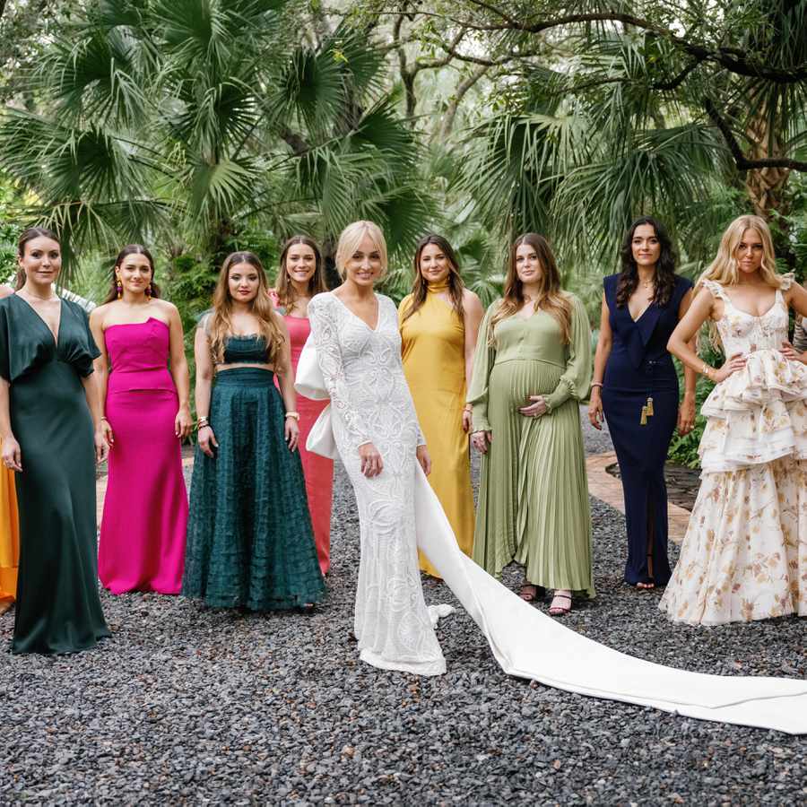a lineup of bridesmaids wearing an array of colorful maxi dresses, from yellow to pink and sage