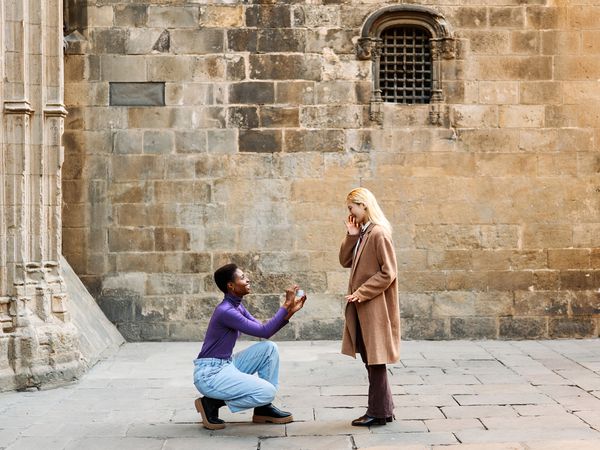 woman proposing to another woman on street