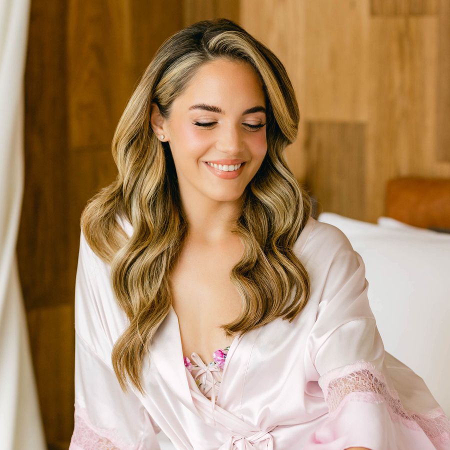 blonde bride with old-Hollywood waves wearing a pink robe