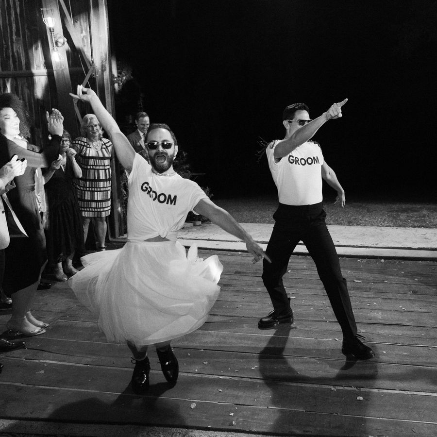 same-sex couple dancing at their wedding reception 