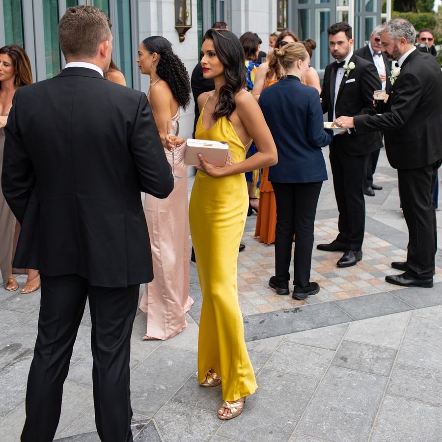 wedding guest wearing a yellow slip dress