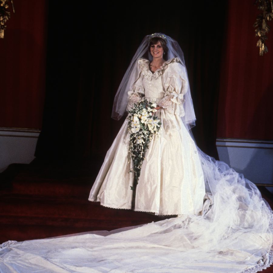 Princess Diana standing in her taffeta ball gown wedding dress with her 25-foot train