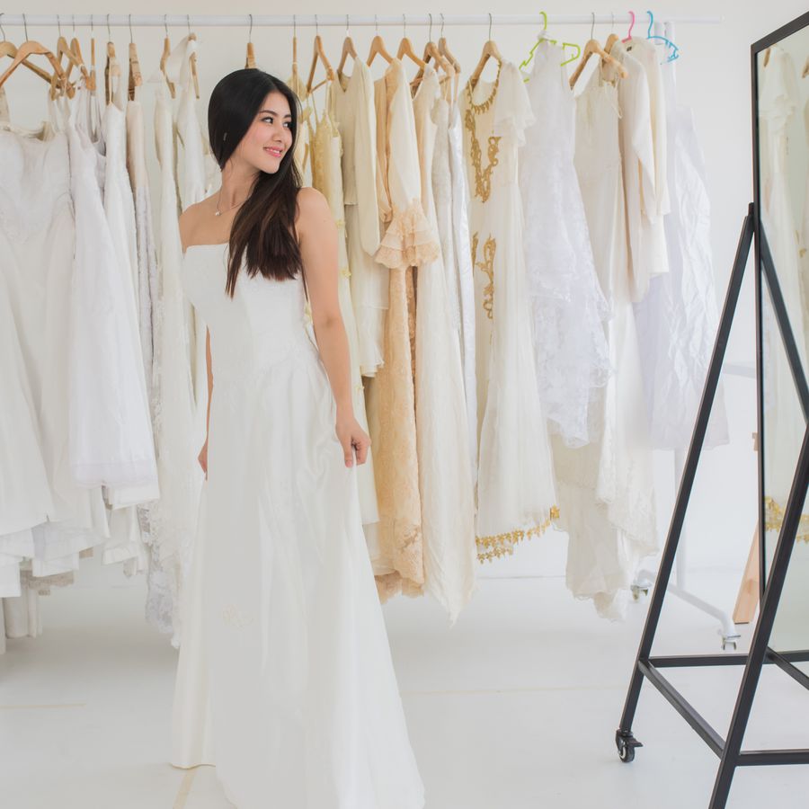 Bride standing in front of a mirror at a bridal salon